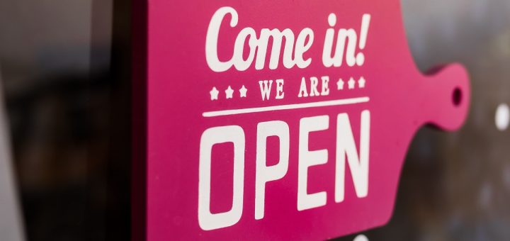 pink 'come in! we're open' signage