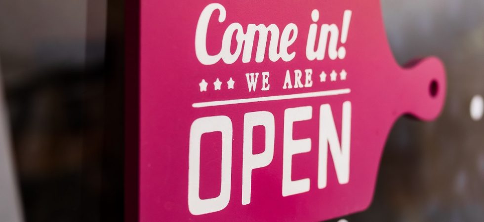 pink 'come in! we're open' signage