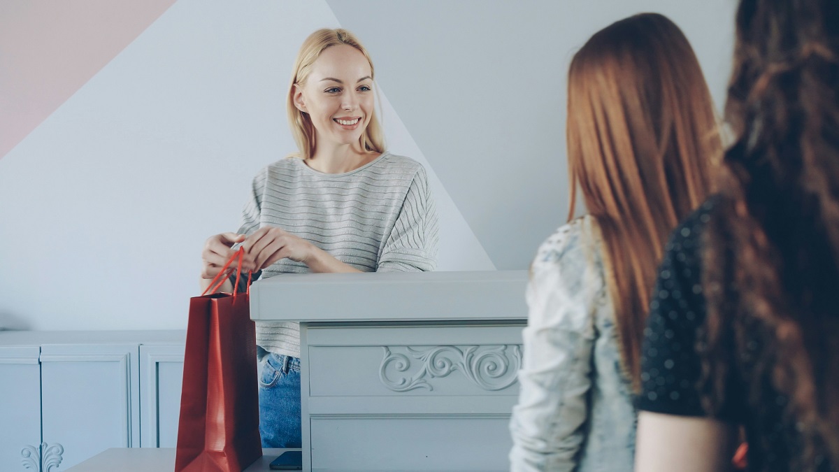 store owner greeting two customers
